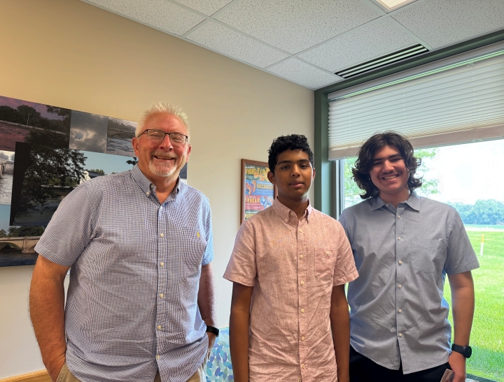 Cedar Falls students Ahan Tandon and Mihai Thompson assisting WHC patient Dave Schmidt with setting up the secure Waverly Health Center patient portal app.
